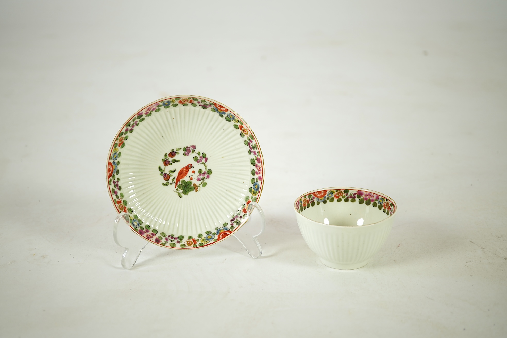 A Worcester Old Worcester Parrot pattern tea bowl and saucer, c.1765-68, saucer 11.5cm in diameter